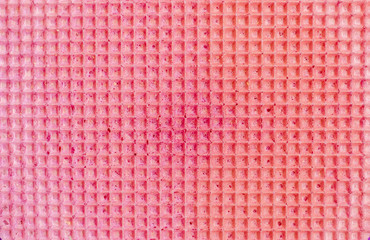Textured abstract background. Colourfull pink waffle. Close up. Flat lay