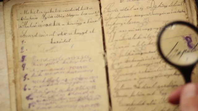 Reading a handwritten vintage book.