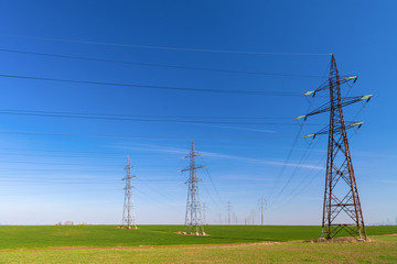 electricity pylons on a farm field