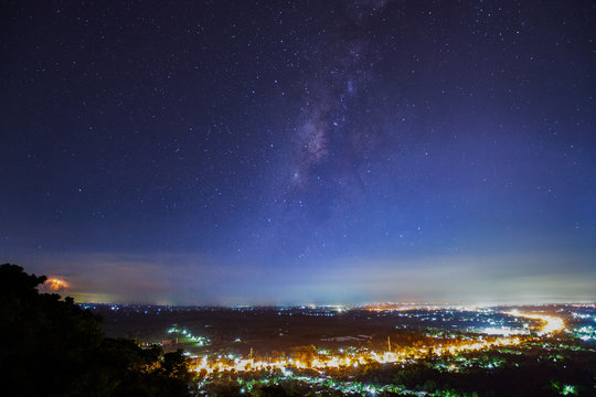 City landscape at nigh with Milky Way galaxy, Long exposure photograph.with grain