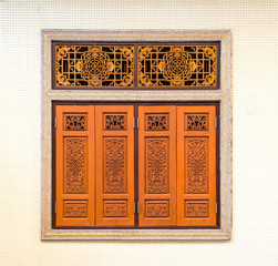 The beautiful Chinese style wooden window carved vintage and mosaic wall.