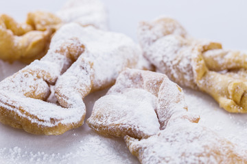 Faworki sprinkled with powdered sugar, closeup