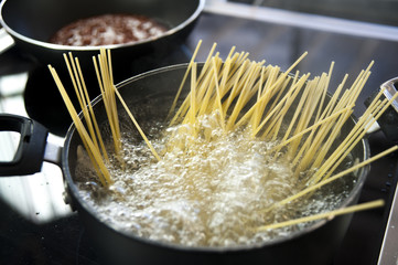 Cooking spaghetti in a pot with boiling water