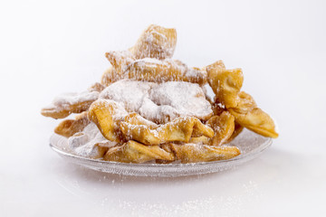 Fresh faworki sprinkled with powdered sugar