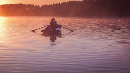 Romantic golden sunset river lake fog loving couple small rowing boat date beautiful Lovers ride during Happy woman man together relaxing water nature around