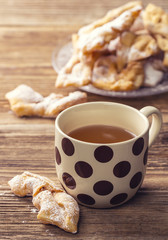 A cup of tea and chrust for a dessert