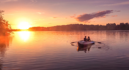Romantic golden sunset river lake fog loving couple small rowing boat date beautiful Lovers ride during Happy woman man together relaxing water nature around - Powered by Adobe