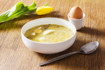 Homemade sour rye soup in a ceramic bowl