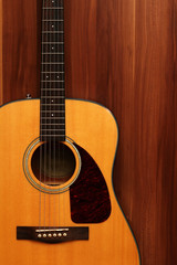 Fototapeta premium Acoustic guitar on a wooden background.