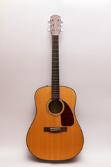 Acoustic guitar on a white background.