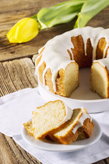 Easter cake on a wooden table with a tulip in the background