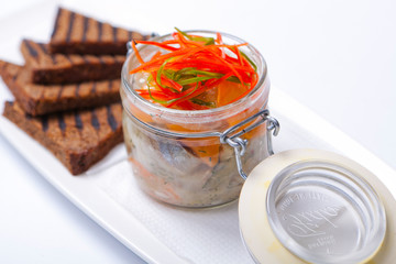 Black bread and herring in glass gar