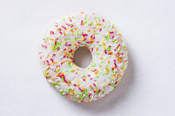 Donut with colorful sprinkles isolated on white