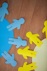 Obraz premium Blue and yellow paper cut-out people on the circle