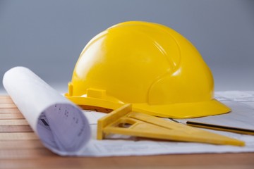 Architectural plan with tools and hard hat - Powered by Adobe