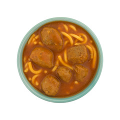 Top view of a bowl of spaghetti and meatballs isolated on a white background.