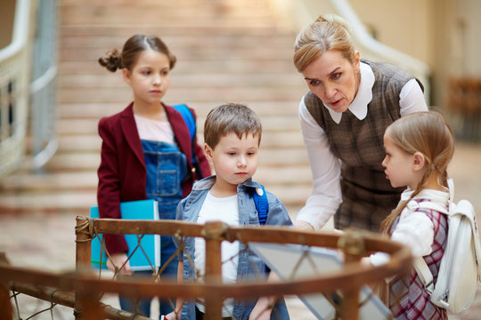 Teacher guiding schoolkids in museum of national history