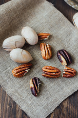 Fototapeta na wymiar Pecan nuts on piece of cloth over wooden table.