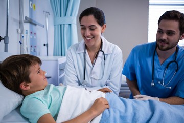 Smiling doctors interacting in ward