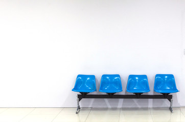 empty blue seats interior building with white wall