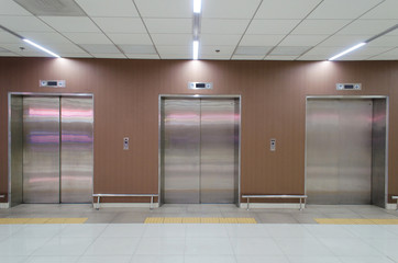  closed metal office building elevator doors in modern building