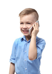 Cute little boy talking by mobile phone on white background