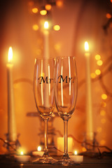 Decorated champagne glasses for gay wedding on table