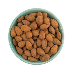 Raw natural almonds in a bowl isolated on a white background.