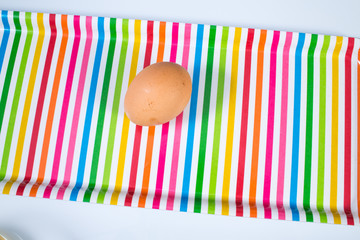 Egg on multicolored tray isolated on white background