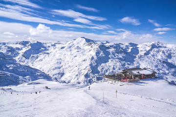 view of ski resort in mountains. Ski slopes. Rest in mountains in the winter. Skiing and snowboards.