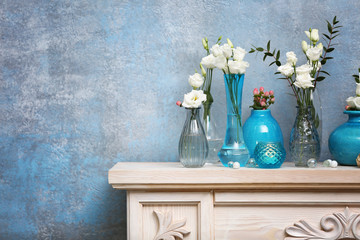 Beautiful composition with fresh flowers on mantelpiece