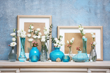 Beautiful composition with fresh flowers on mantelpiece