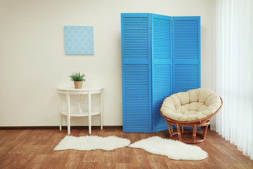 Light room interior with blue folding screen