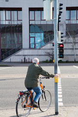Fahrradfahrer hält an roter Ampel