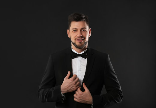 Handsome young man posing on dark background