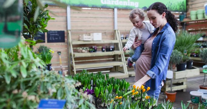 Pregnant mother with daughter at garden centre