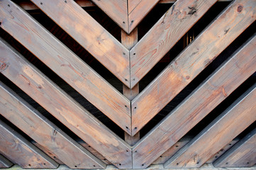 Oblique wooden slats.Bonded at an angle of 45 degrees. Fence, fencing