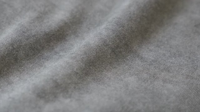 Shiny gray modern clothing sample 2160p 30fps UltraHD panning footage - Dark grey smoked color fine t-shirt fabric slow pan 4K 3840X2160 UHD video 