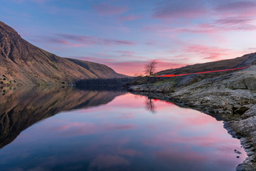 Light Trails with glowing pink and purple sunset at Wast Water in the English Lake District.