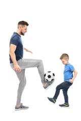Rolgordijnen Handsome man and his son playing football on white background © Africa Studio