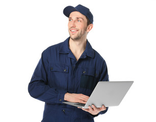 Handsome auto mechanic with laptop on white background