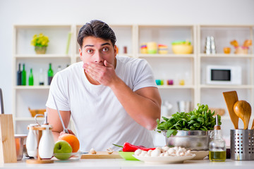 Young male cook working in the kitchen