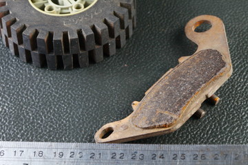 The old damaged and dirty brake pad represent the car maintenance concept related idea.