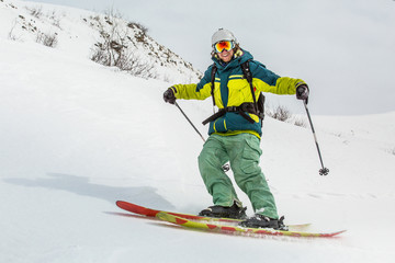 Fototapeta na wymiar skier skiing on fresh snow on ski slope on Sunny winter day in the ski resort in Georgia