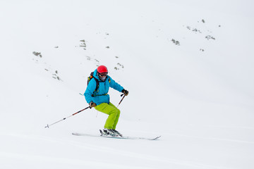 Fototapeta na wymiar skier skiing on fresh snow on ski slope on Sunny winter day in the ski resort in Georgia