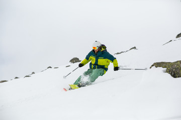 skier skiing on fresh snow on ski slope on Sunny winter day in the ski resort in Georgia