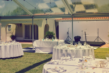 Special event decorated area and white furniture on the green grass sunny outside background