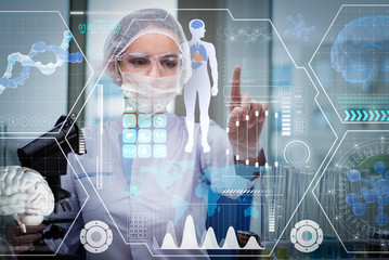 Doctor in futuristic medical concept pressing button