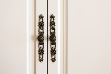 Interior detail, white door with decorative handle