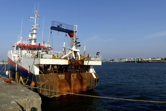 Stern view of a trawler fishing boat docked at the fishing harbor of Lorient, France
